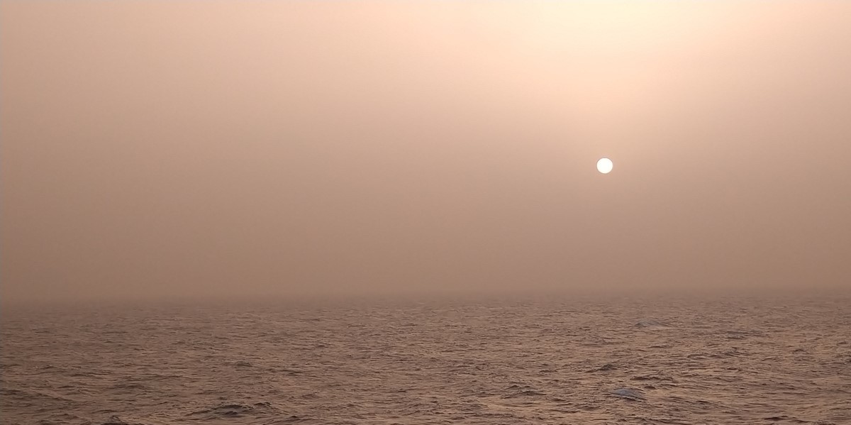 A dusty sunset over the equatorial North Atlantic Ocean